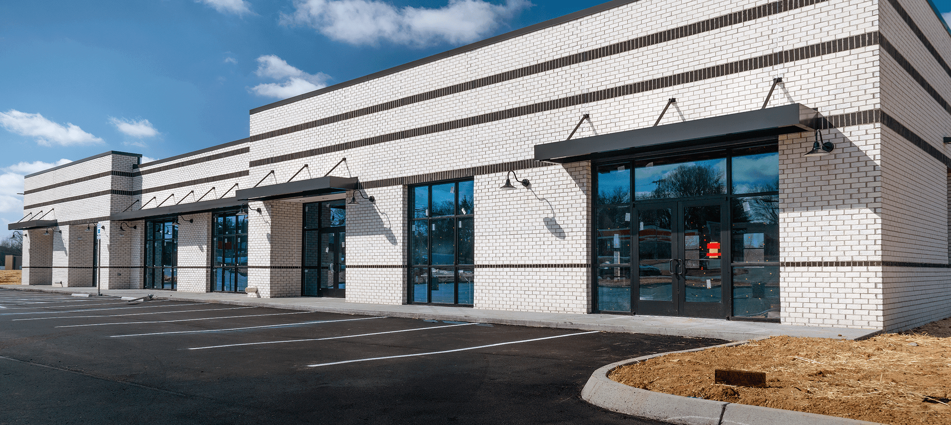 Empty commercial building with large windows.
