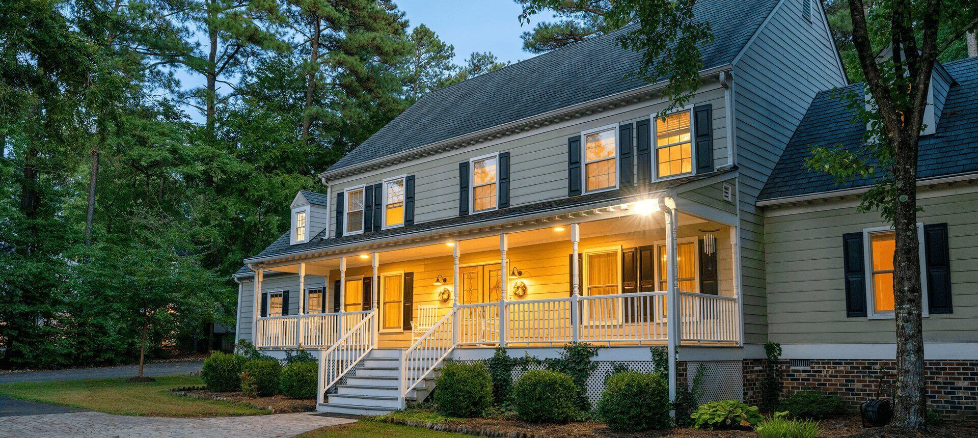 Large house with illuminated front porch.